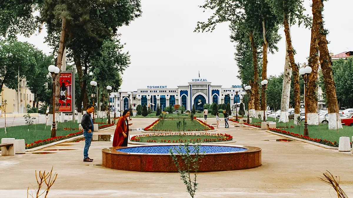 Tashkent railway station building with landscaped park and fountain in front