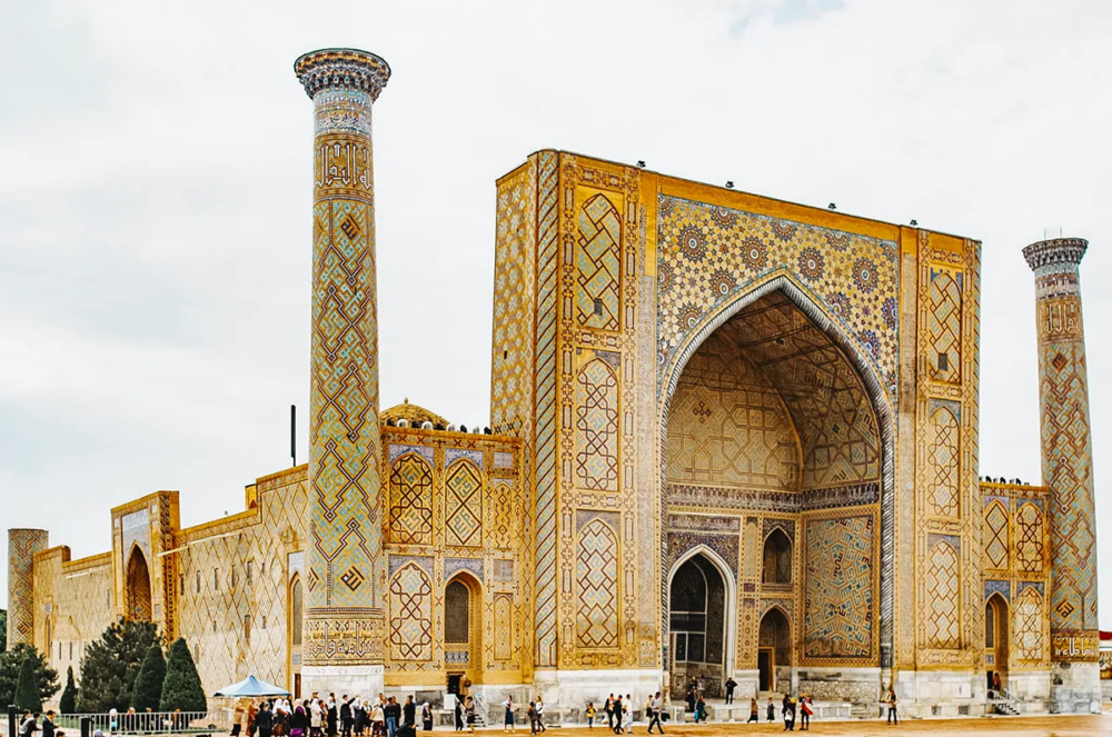 Ulugh Beg Madrasa at Registan Square in Samarkand with tall minarets and geometric tilework